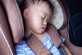 Cute little Asian 1 year toddler baby boy child sleeping in modern car sea Royalty Free Stock Photo