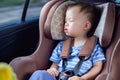 Cute little Asian 1 year toddler baby boy child sleeping in modern car sea Royalty Free Stock Photo