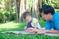 Asian 2 - 3  years old toddler boy child painting with crayons, kid coloring with father at park Royalty Free Stock Photo