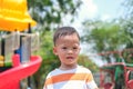 Cute little Asian 2 - 3 years old toddler boy child sweating during having fun playing, exercising outdoor at playground, Heat Royalty Free Stock Photo