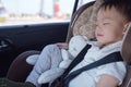 Asian 2 - 3 years toddler baby boy child sleeping in modern car seat. Child traveling safety on the road Royalty Free Stock Photo
