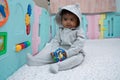 Cute little asin baby boy sitting and play toy in room