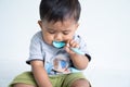 Cute little asin baby boy with spoon Royalty Free Stock Photo