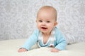 Cute little baby with blue eyes giving big smile into the camera Royalty Free Stock Photo