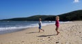 Cute little baby boy and girl running on sand beach amazing nature scenery enjoying happy childhood