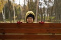 Cute little baby boy is having fun in the autumn Park with his family on a Sunny autumn day.