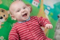 Cute little baby boy lying on his back smiling Royalty Free Stock Photo