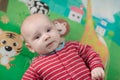 Cute little baby boy lying on his back smiling Royalty Free Stock Photo