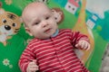 Cute little baby boy lying on his back smiling Royalty Free Stock Photo