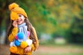 Cute little baby girl play in autumn park with fallen leaves Royalty Free Stock Photo