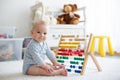 Cute little baby boy, playing with abacus at home Royalty Free Stock Photo