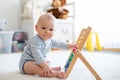 Cute little baby boy, playing with abacus at home Royalty Free Stock Photo