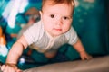 Cute little baby boy playing in colorful playpen, indoors. Beautiful child having fun at nursery Royalty Free Stock Photo