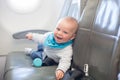 Cute little baby boy, playing with toys on board of aircraft Royalty Free Stock Photo