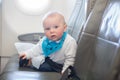 Cute little baby boy, playing with toys on board of aircraft Royalty Free Stock Photo