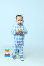 Cute little baby boy wearing on sleepwear standing.