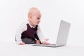 Cute little baby boy sitting on a white background in front of a Royalty Free Stock Photo