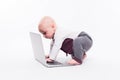 Cute little baby boy sitting on a white background in front of a Royalty Free Stock Photo