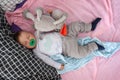 A cute little baby boy is sleeping peacefully and relaxed on his bed with toys Royalty Free Stock Photo