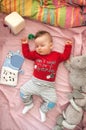 A cute little baby boy is sleeping peacefully and relaxed on his bed with toys Royalty Free Stock Photo