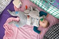 A cute little baby boy is sleeping peacefully and relaxed on his bed with toys Royalty Free Stock Photo