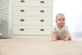Cute little baby crawling on carpet indoors, space Royalty Free Stock Photo