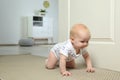 Cute little baby crawling on carpet, space for text Royalty Free Stock Photo