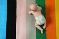 Cute little baby crawling on colorful carpet indoors with space for text Royalty Free Stock Photo