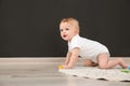 Cute little baby crawling on rug indoors Royalty Free Stock Photo