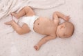 Cute little baby in diaper sleeping on bed, top view Royalty Free Stock Photo