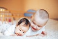 Cute little baby with elder brother lying on bed at home Royalty Free Stock Photo