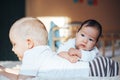 Cute little baby with elder brother lying on bed at home Royalty Free Stock Photo