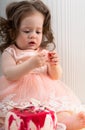 Cute little baby girl eating cake with hands Royalty Free Stock Photo