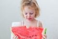 Cute little baby girl eating watermelon slice on light background Royalty Free Stock Photo