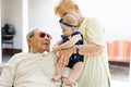 Cute little baby girl with grandmother and grandfather on summer day in garden Royalty Free Stock Photo