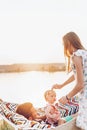 Cute little baby girl with her parents on a weekend getaway, happy mother caressing daughter, father with baby in a hammock Royalty Free Stock Photo