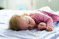 Cute little baby girl at home lying on bed, sleeping Royalty Free Stock Photo