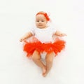 Cute little baby girl lying in the red skirt Royalty Free Stock Photo