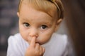 Cute little baby girl picking her nose Royalty Free Stock Photo