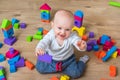 Cute little baby girl playing with colorful toy blocks Royalty Free Stock Photo