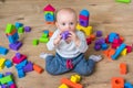 Cute little baby girl playing with colorful toy blocks Royalty Free Stock Photo