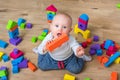 Cute little baby girl playing with colorful toy blocks Royalty Free Stock Photo