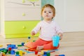 Cute little baby girl playing with educational toys. Happy healthy child having fun with colorful different wooden Royalty Free Stock Photo