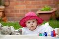 Cute little baby girl playing with her toys