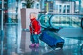 Cute little baby girl on suitcase travel in airport Royalty Free Stock Photo