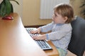 cute little baby girl typing on keyboard sitting at computer Royalty Free Stock Photo