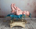Cute little baby with legs up on scales Royalty Free Stock Photo
