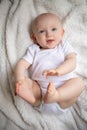 cute little baby lies on a white blanket Royalty Free Stock Photo