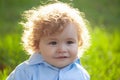 Cute little baby on the meadow field. Toddler child walking outdoor, family vacations. Baby face closeup. Funny little Royalty Free Stock Photo