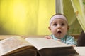 Cute little baby next to a big book Royalty Free Stock Photo